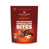 Navitas Organics Superfood+ Salted Peanut Chocolate BITES with dark chocolate-covered salted peanuts blended into bite-sized pieces on packaging against a white background.