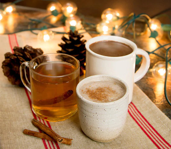 Three mugs of spiced apple cider made with Navitas Organics Camu Powder