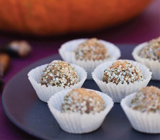 Plate of vegan pumpkin spice truffles coated with hemp seeds