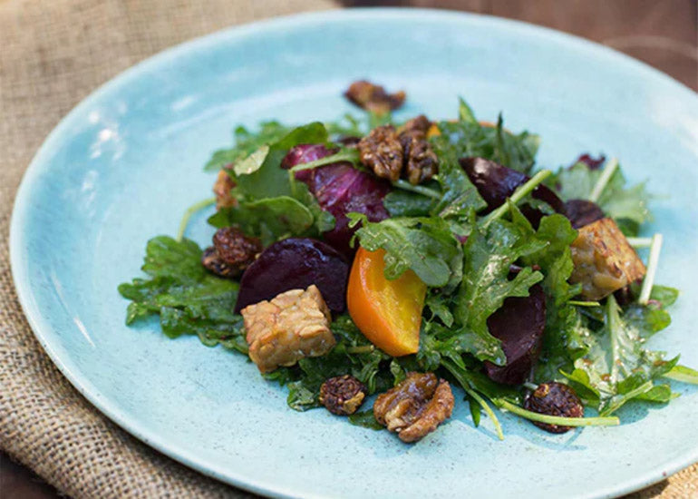 A plate of salad topped with Navitas Organics Goldenberries.