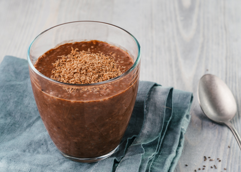 Glass bowl of superfood chia seed pudding made with Navitas Organics Cacao Powder and Maca Powder