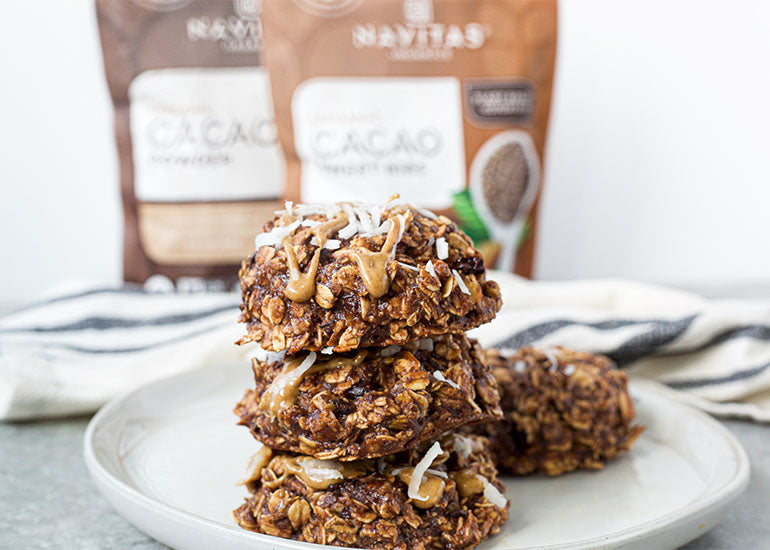Chocolate trail mix breakfast cookies made with Navitas Organics Cacao Powder and Cacao Nibs on a plate.