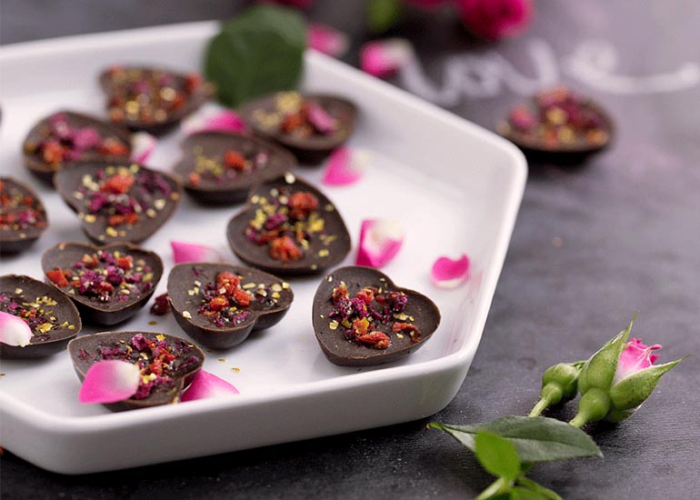 Chocolate hearts made with Navitas Organics cacao, topped with rose petals.