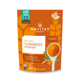 A package of Navitas Organics Superfoods Turmeric Powder, featuring a USDA Organic and Non-GMO Verified seal, with an image of a spoonful of turmeric and a plant-based icon on the front.

