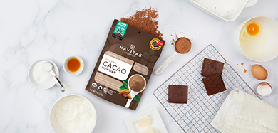Navitas Organics Regenerative Organic Certified Cacao Powder with fudge brownies and baking utensils