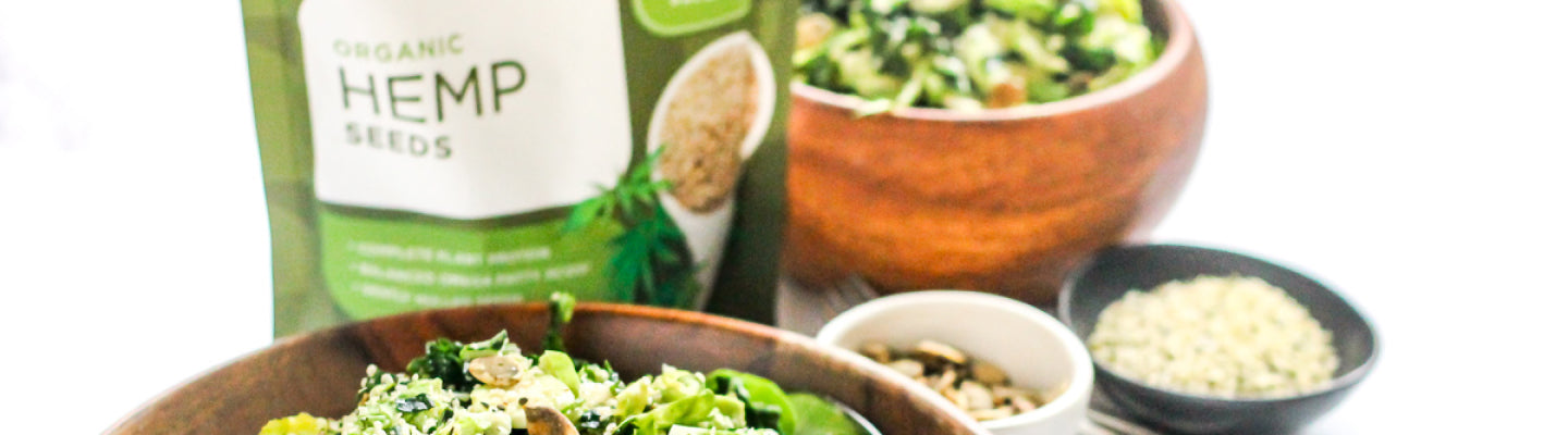 A bag of Navitas Organics hemp seeds with a bowl of salad