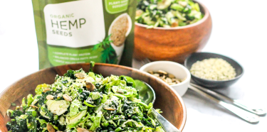 A bag of Navitas Organics hemp seeds with a bowl of salad